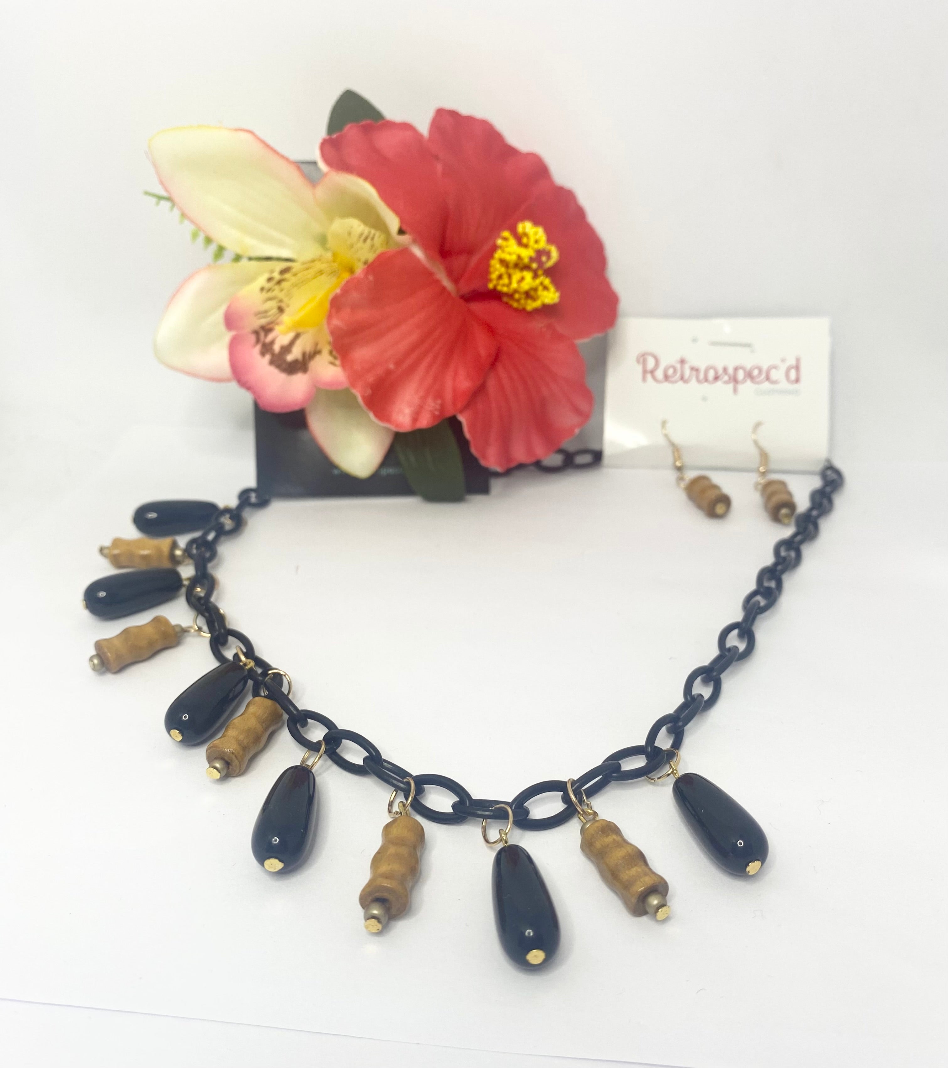 Bamboo Tiki Style Necklace Featuring Bamboo style beads with Black pendent beads on a black acrylic chain.