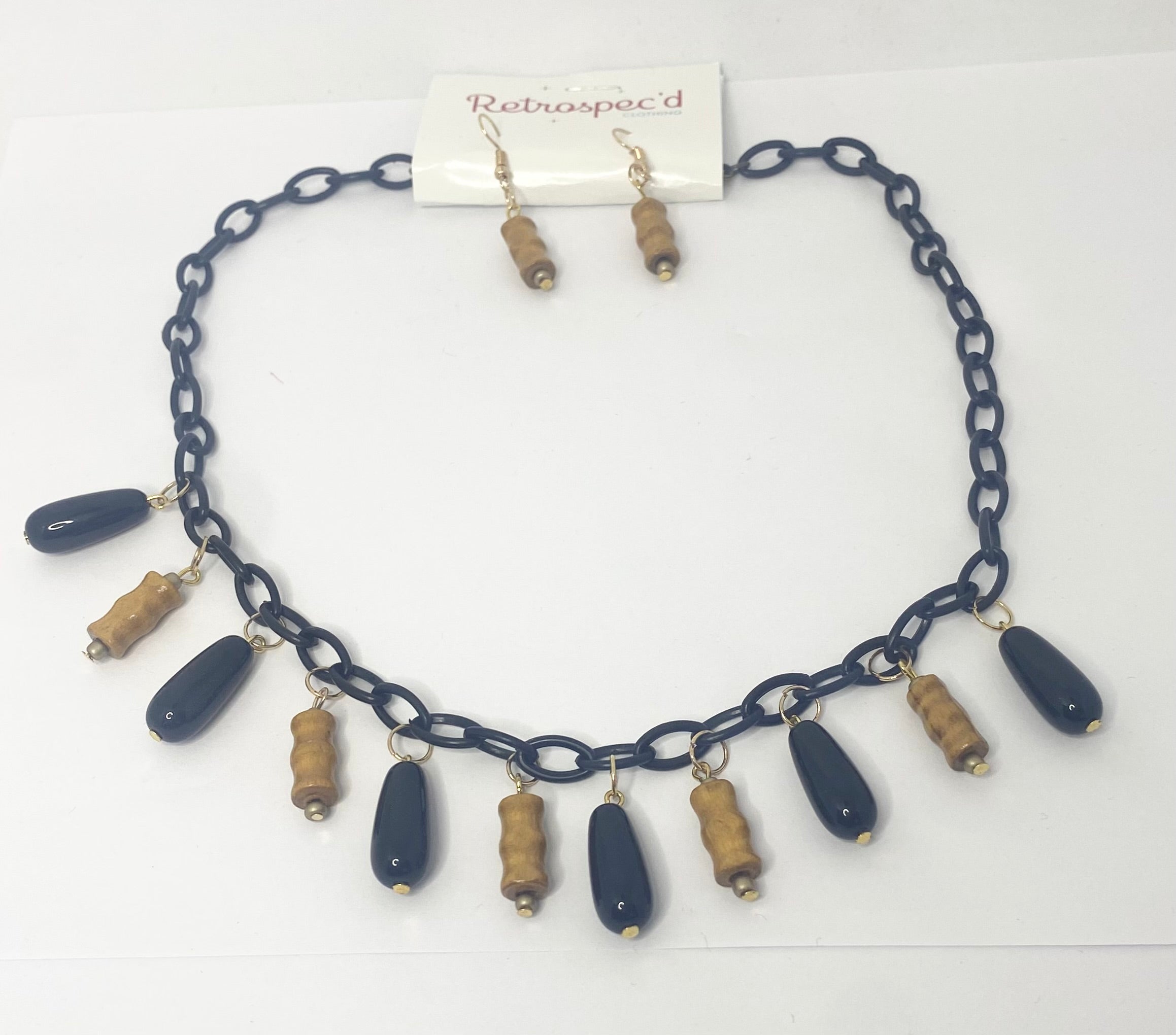 Bamboo Tiki Style Necklace Featuring Bamboo style beads with Black pendent beads on a black acrylic chain.