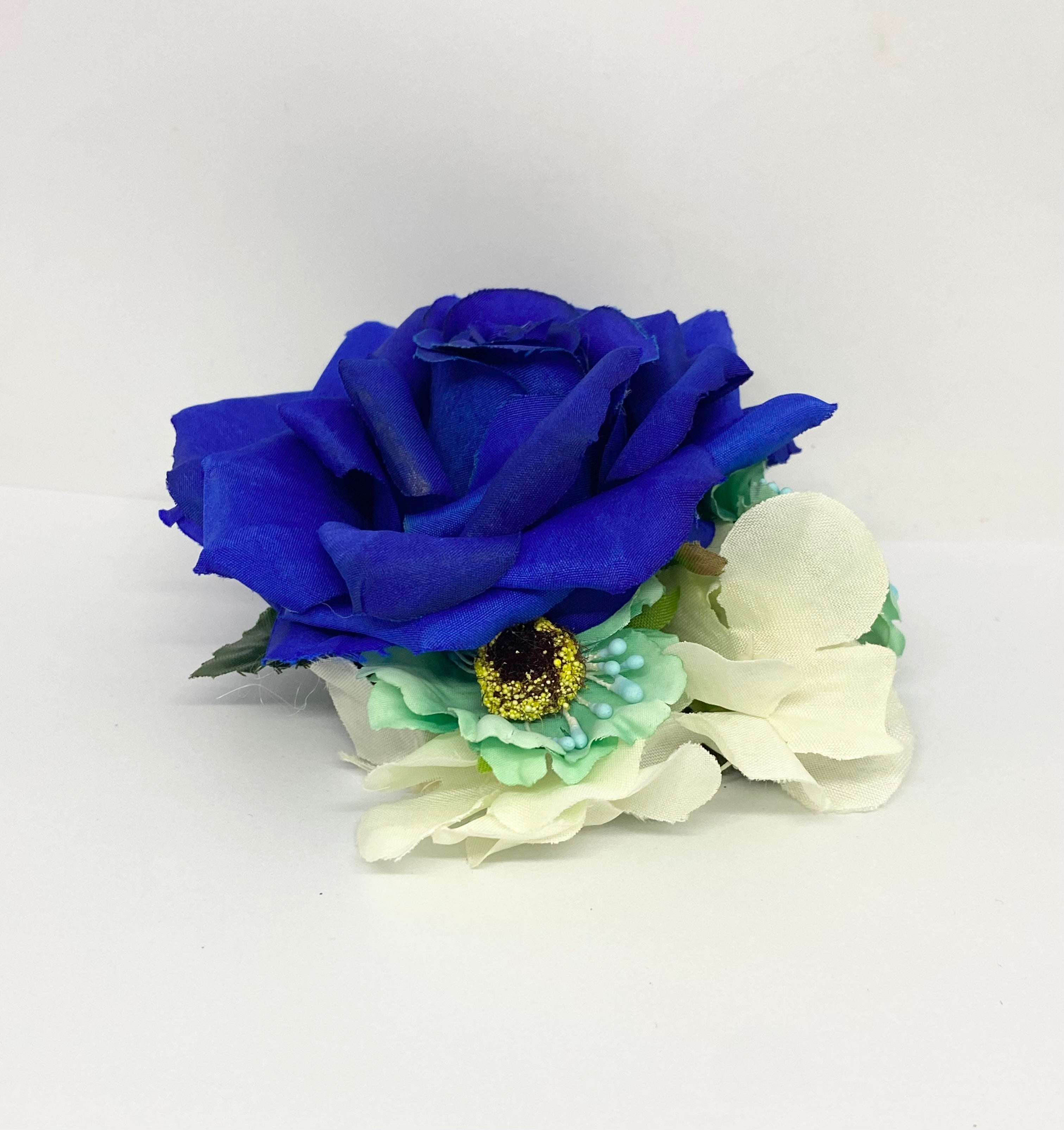 Blue fantasy swan rose 1940s/1950s hair flower A royal blue hair flower with a central rose and smaller mint leaves, attached to an alligator clip.