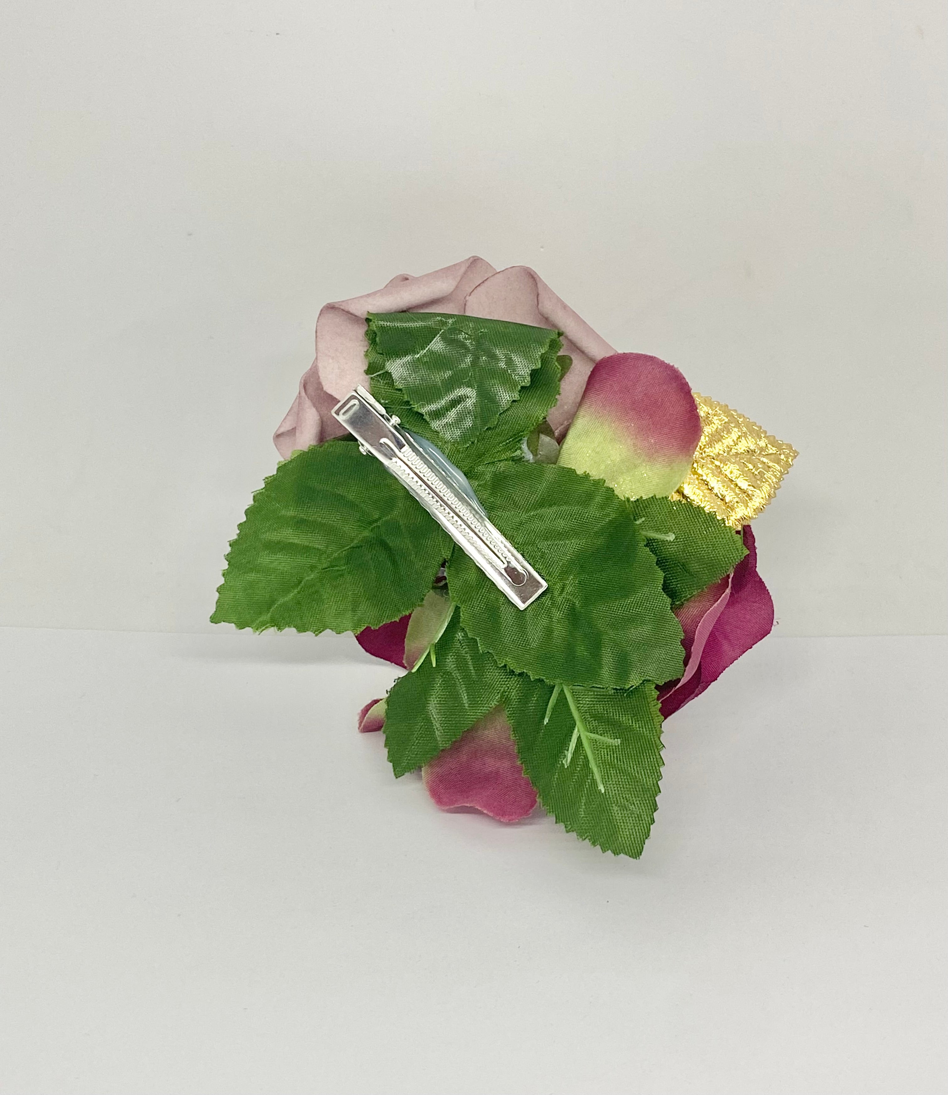 Burgundy Dream hair flower arrangement featuring a dark burgundy rose and a light purple rose with a gold accent, attached to a hair clip.