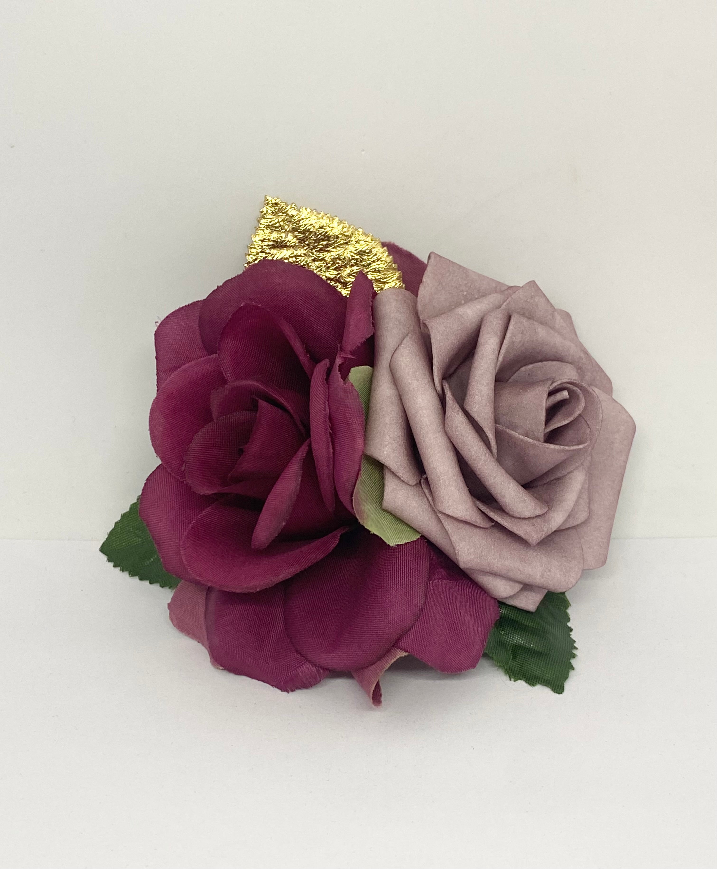 Burgundy Dream hair flower arrangement featuring a dark burgundy rose and a light purple rose with a gold accent, attached to a hair clip.