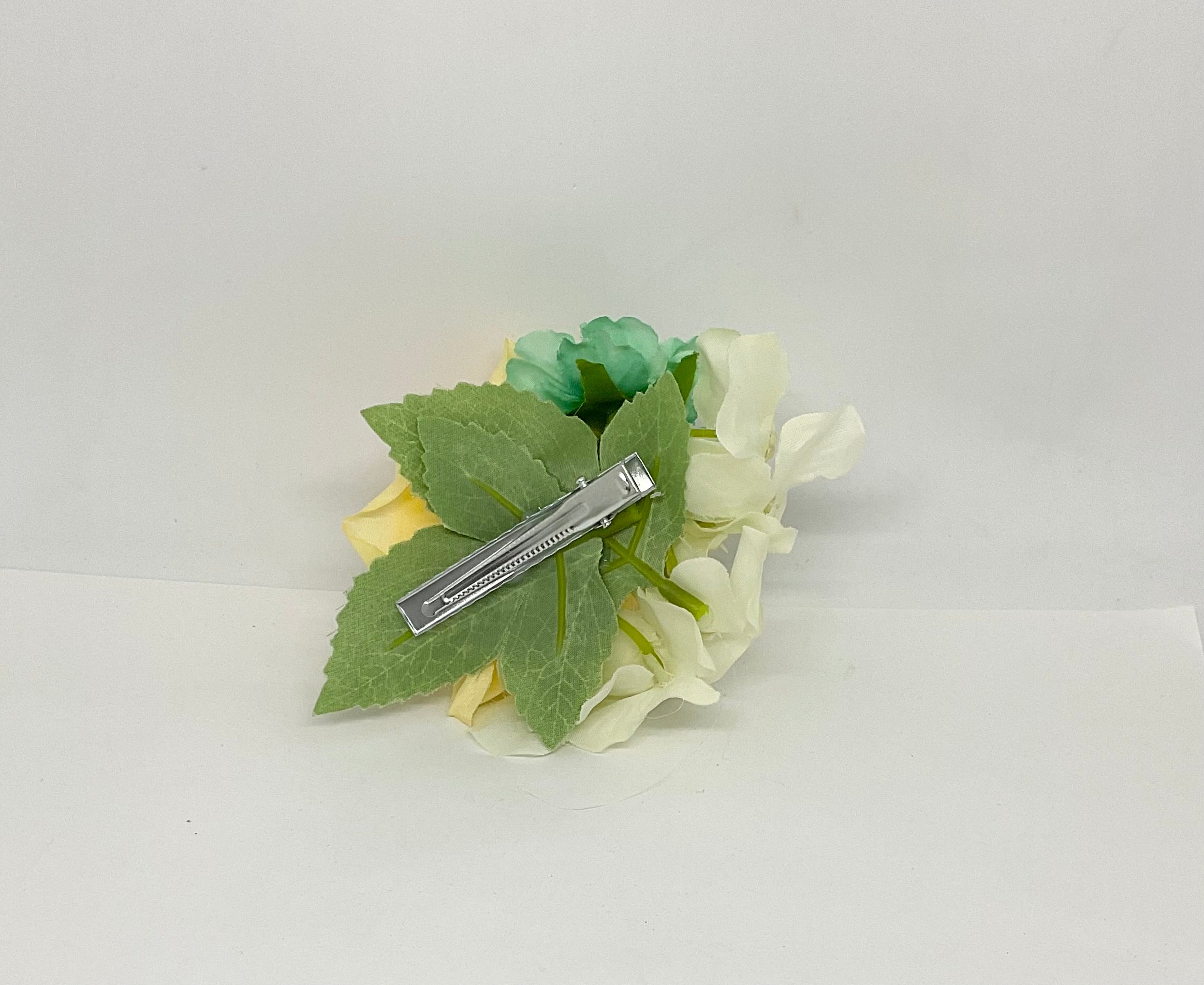 Buttercup rose with turquoise and white flowers with green leaves.pin-up vintage flowers