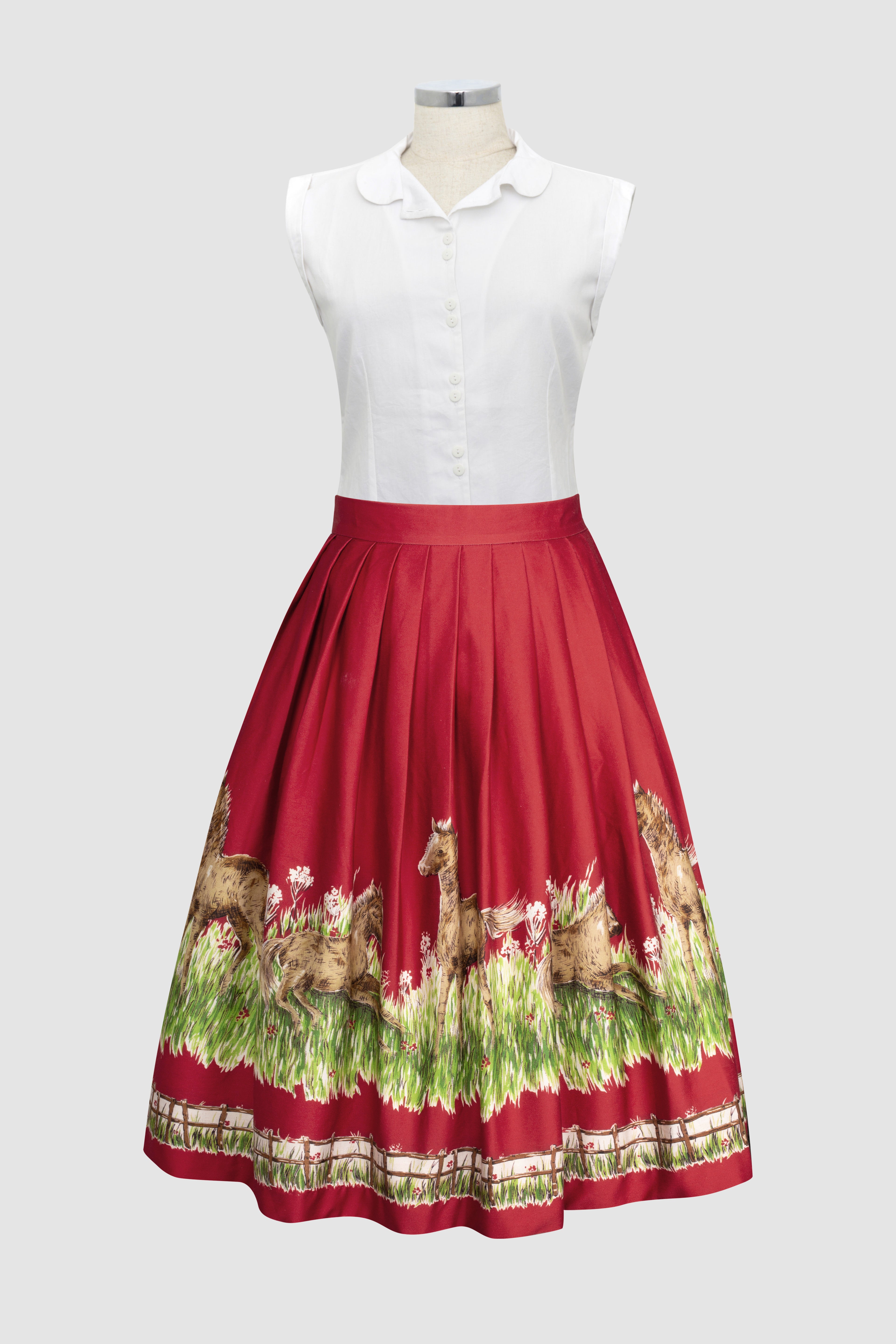 Corina 1950s style skirt with little pony’s in a green Pasture. Country novelty scene on a red background.