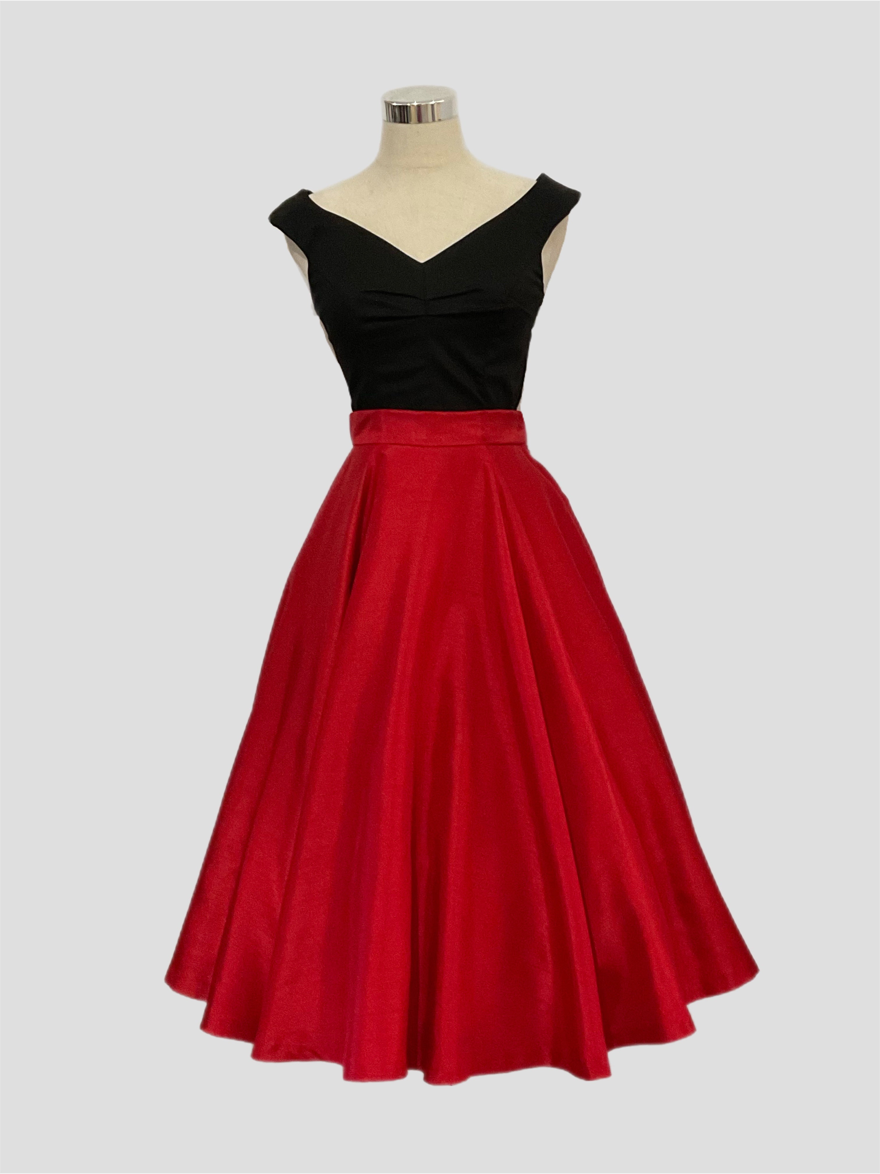 Grace Kelly A vintage 1950's style full circle skirt in red shantung with side zipper and side seam pockets, displayed on a mannequin with a black scarlet  top.