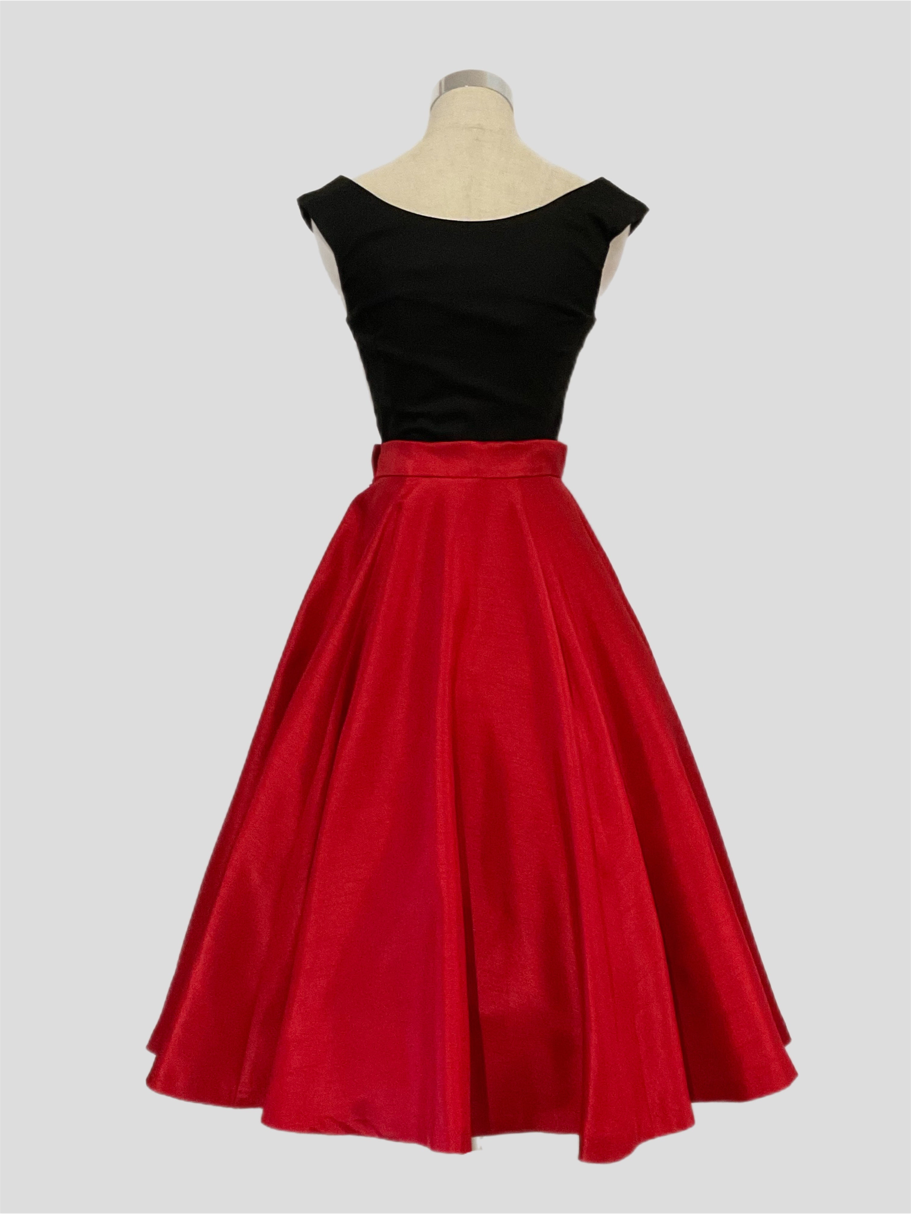Grace Kelly A vintage 1950's style full circle skirt in red shantung with side zipper and side seam pockets, displayed on a mannequin with a black scarlet  top.