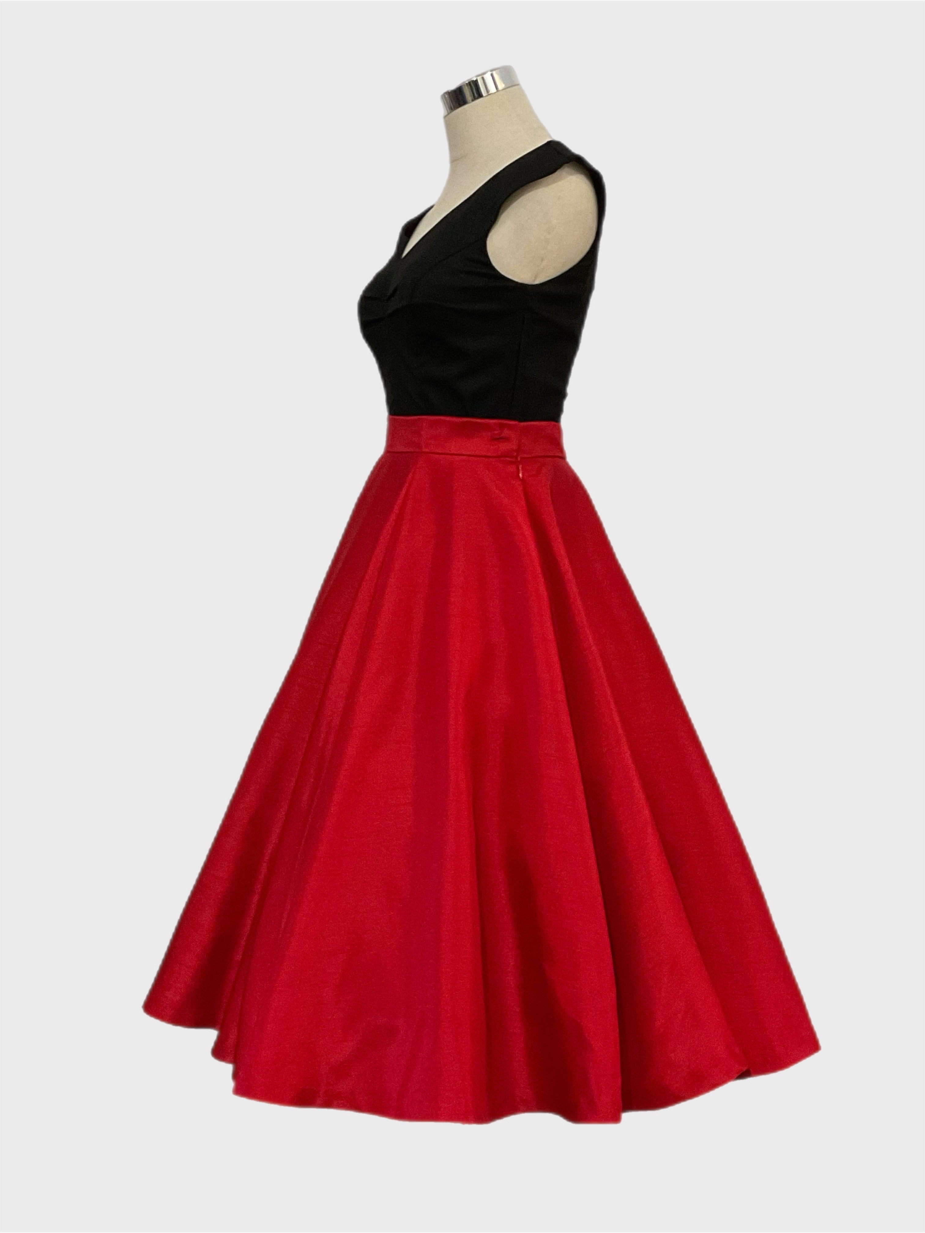Grace Kelly A vintage 1950's style full circle skirt in red shantung with side zipper and side seam pockets, displayed on a mannequin with a black scarlet  top.