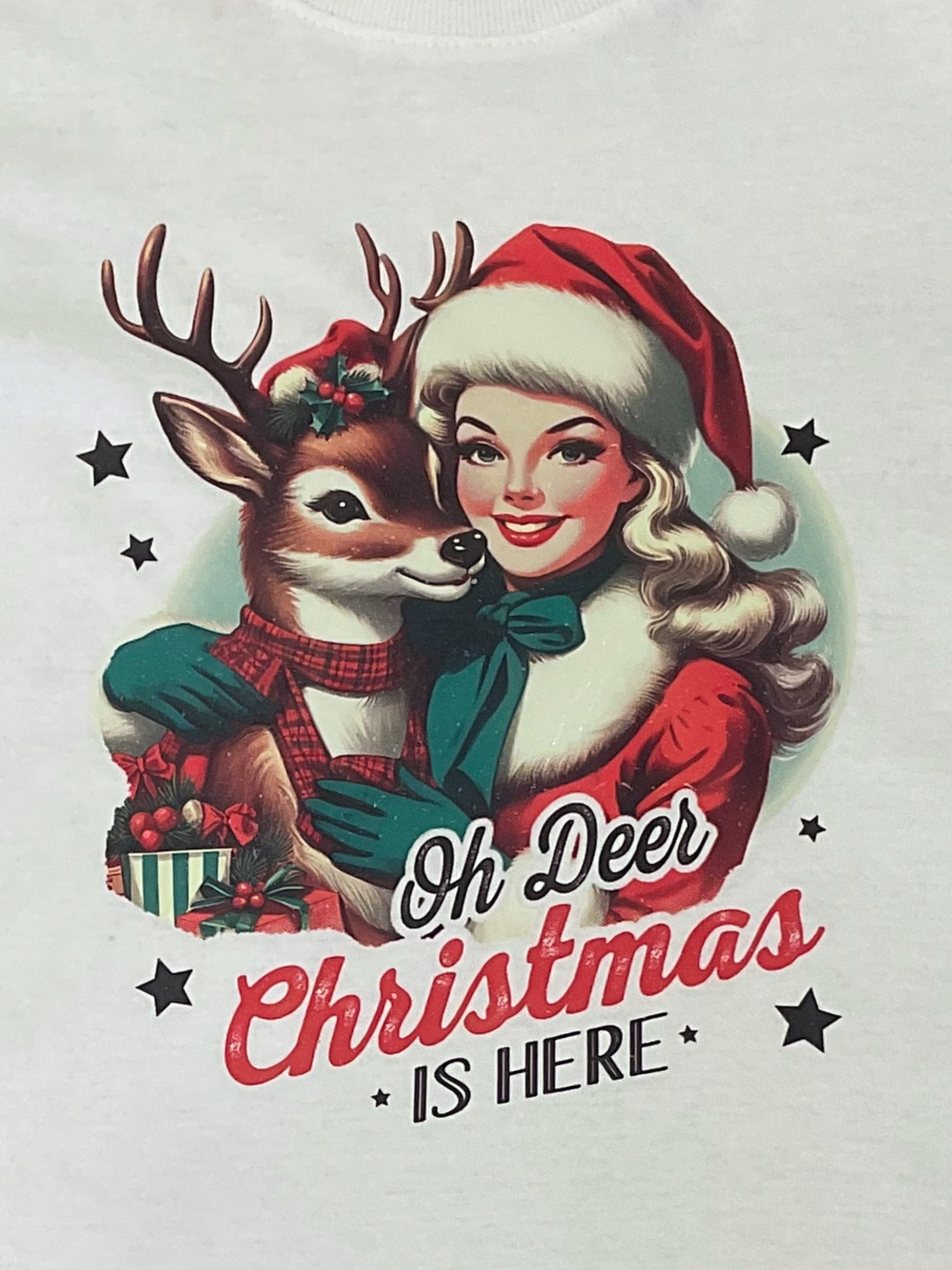 White vintage style T-shirt with a Christmas themed print, featuring a reindeer,  and the text 'Oh Deer, It's Christmas'.