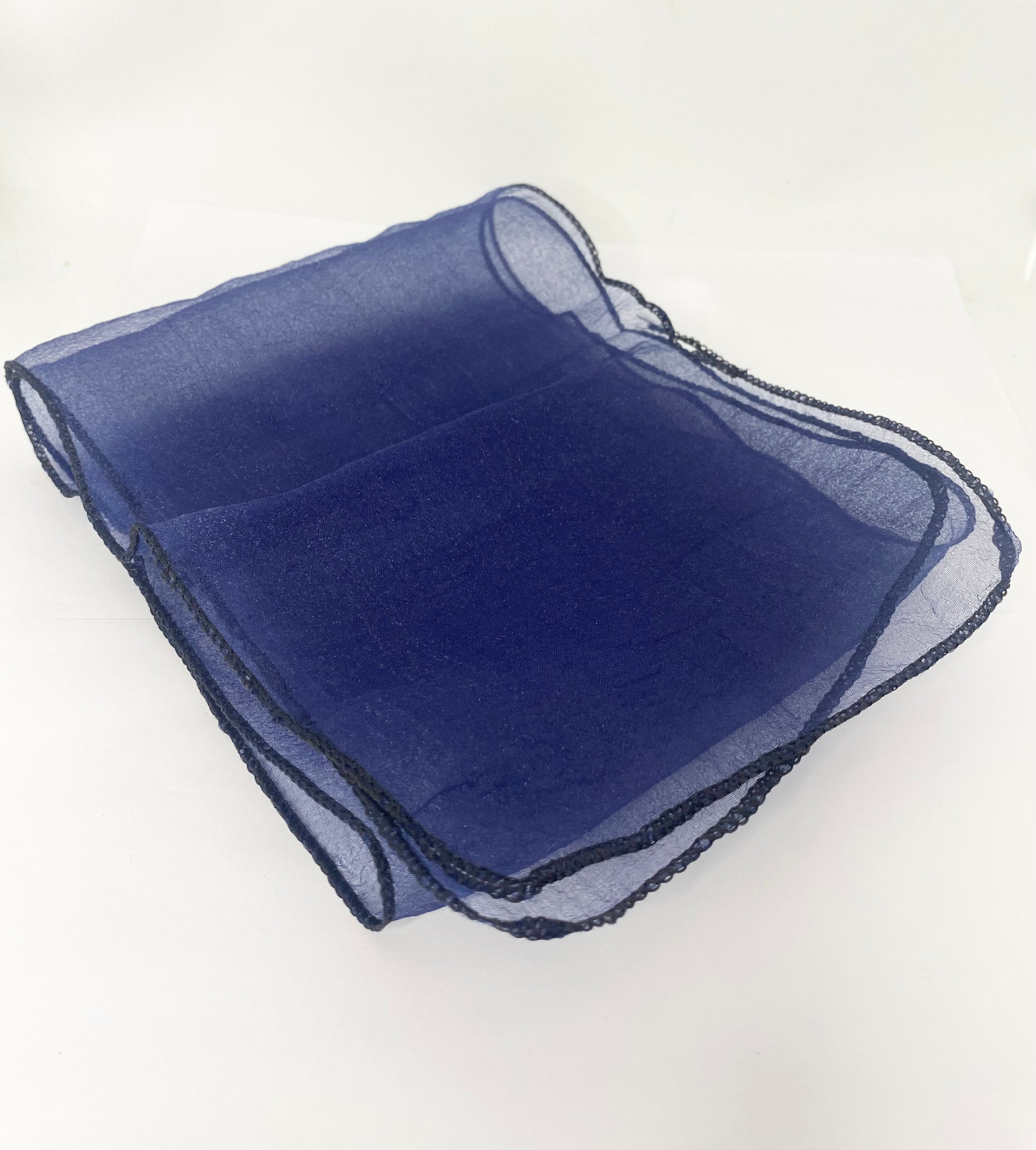 Folded navy blue fabric on a white background