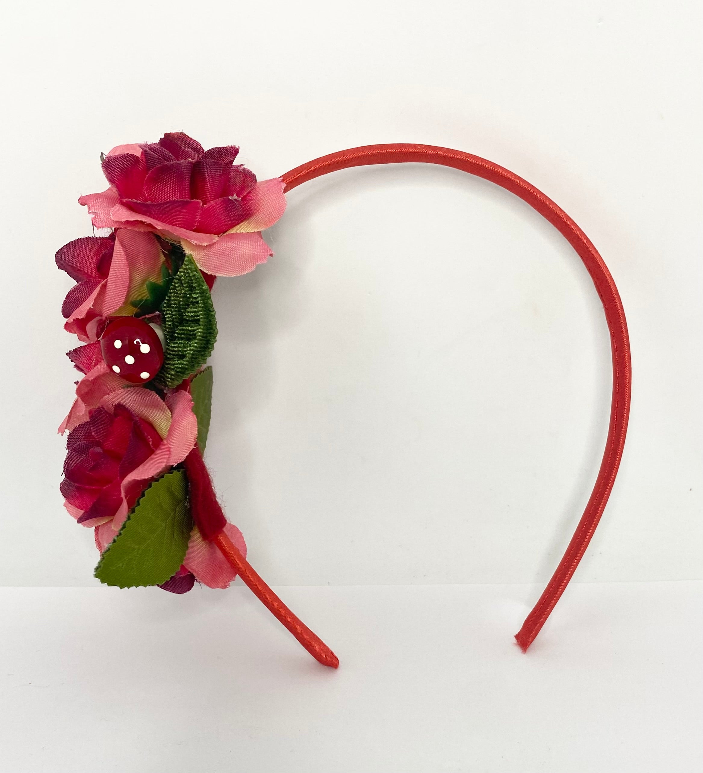 red mushroom Floral headband with pink flowers and a red headband on a white background