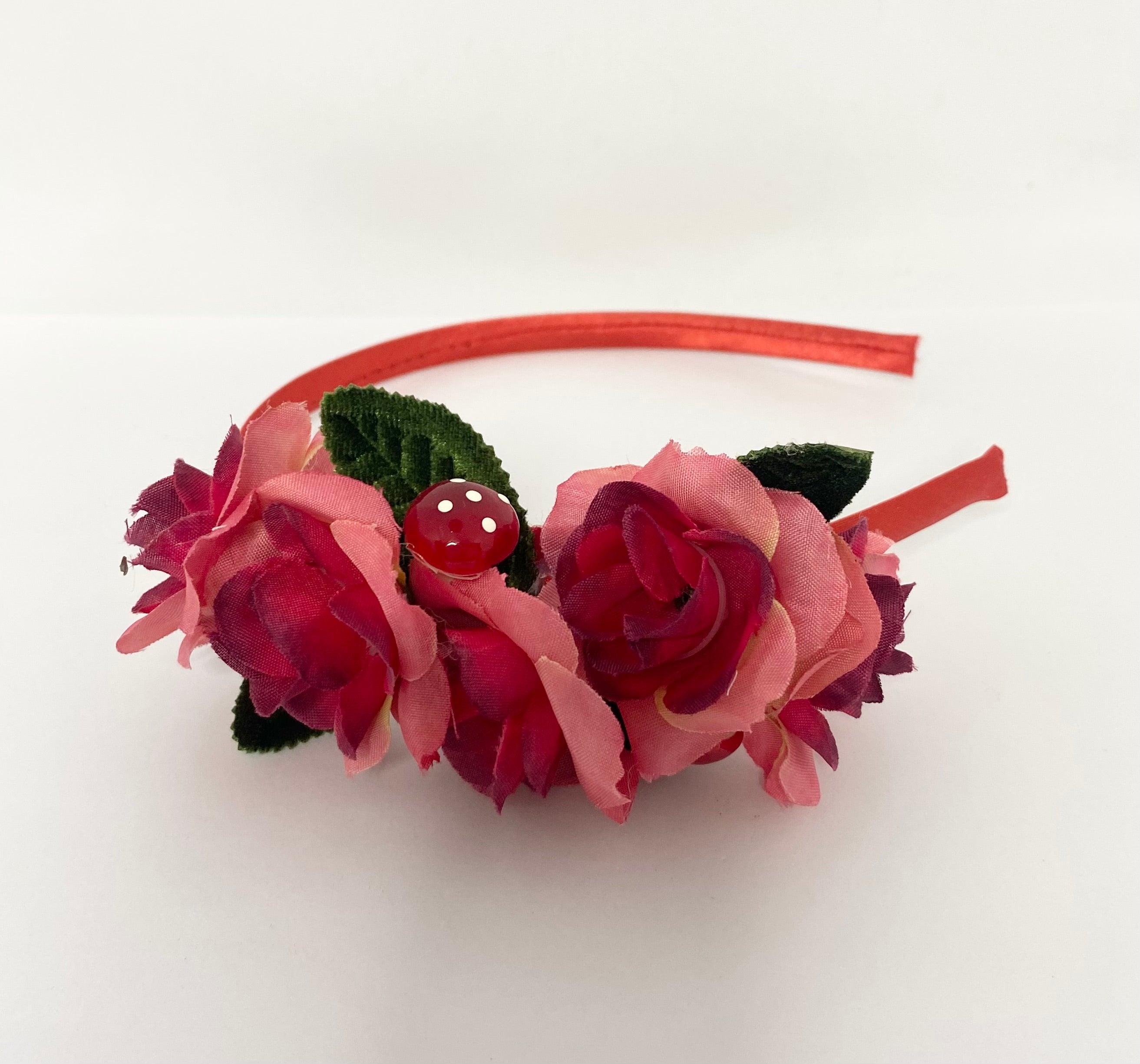 red mushroom Floral headband with pink flowers and a red headband on a white background