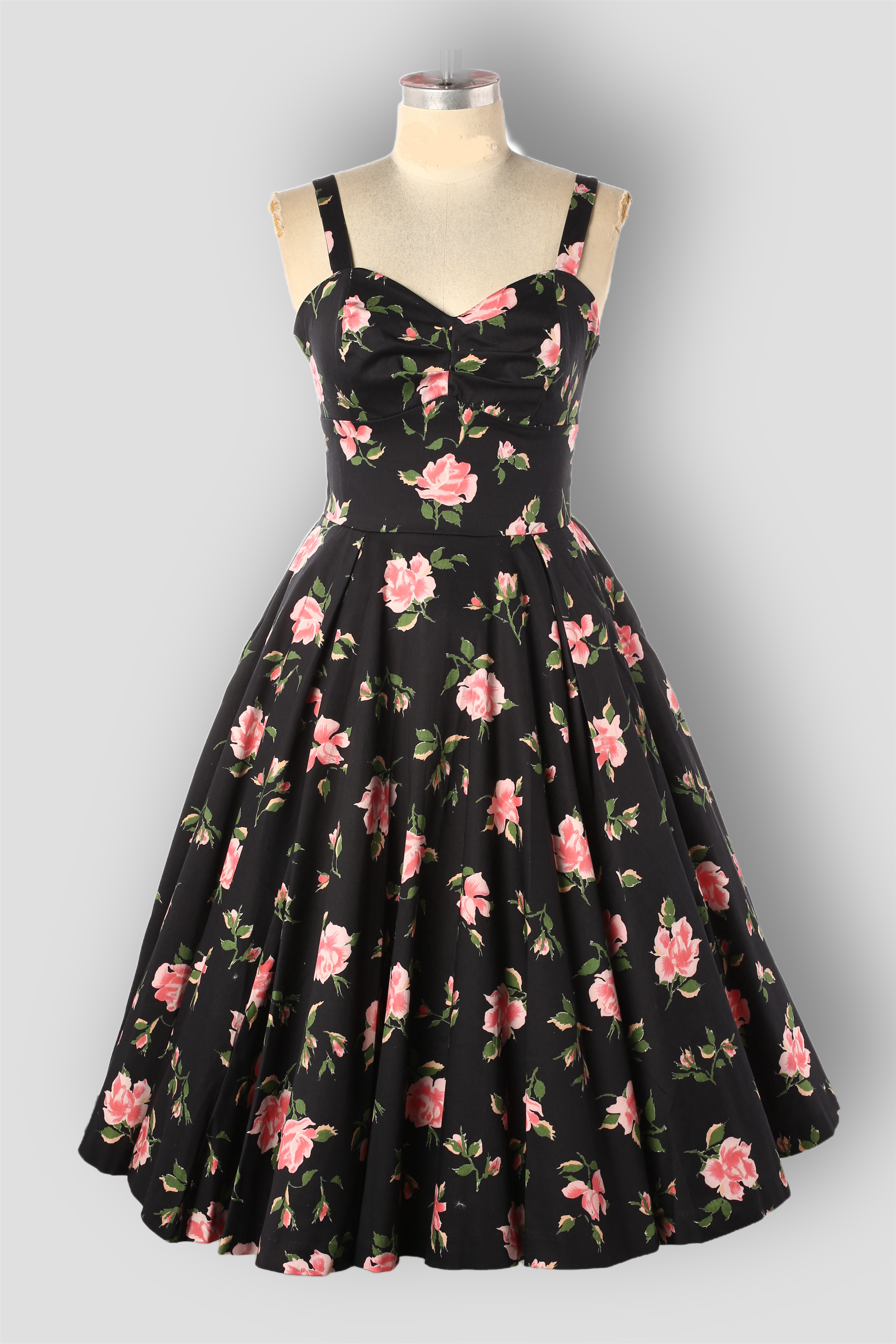 Sandi Beauty Queen isA1950s  vintage style dress with a full circle skirt, adjustable straps, and floral print