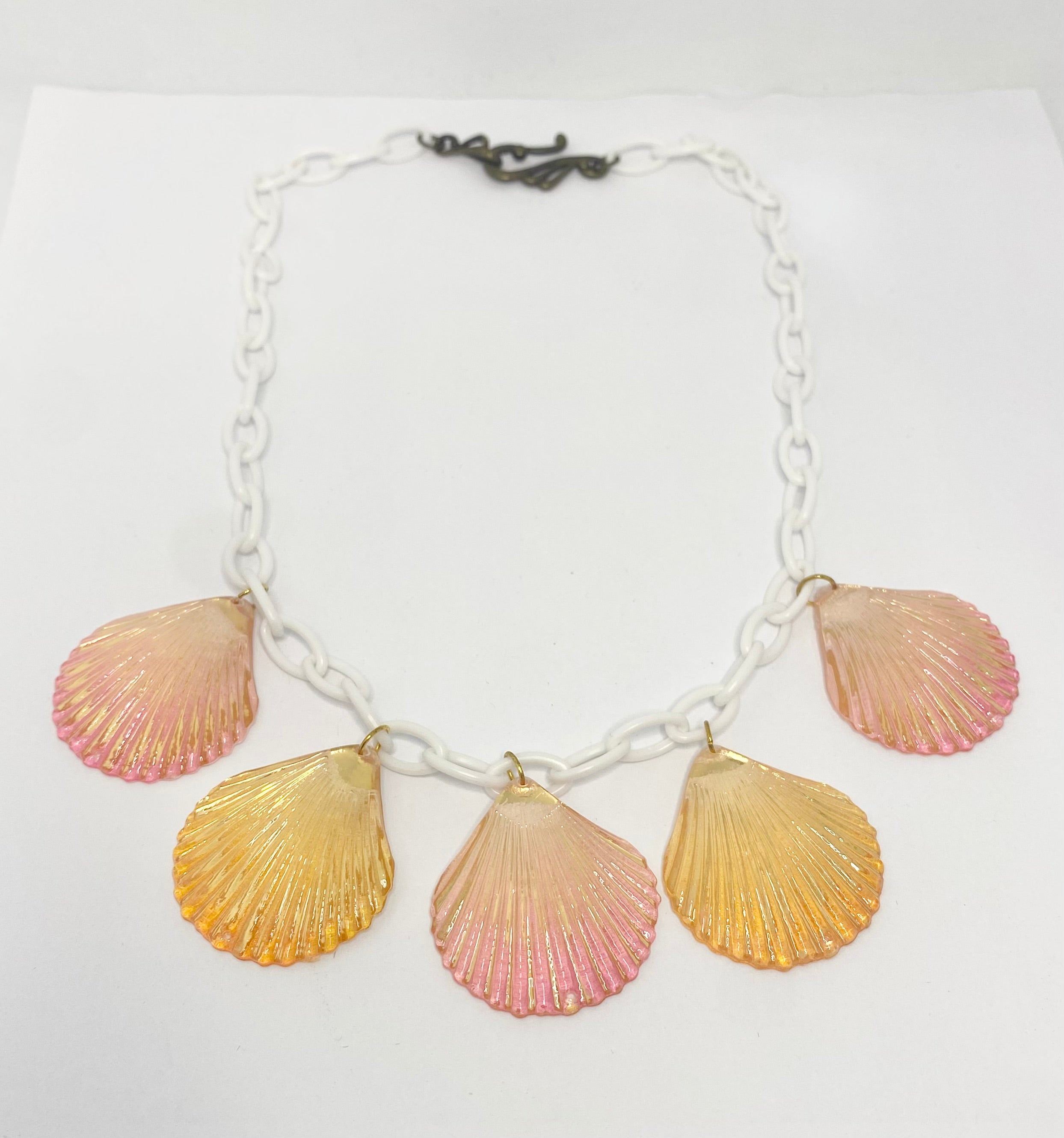  Shelly Necklace with pink and gold shell pendants on a white background