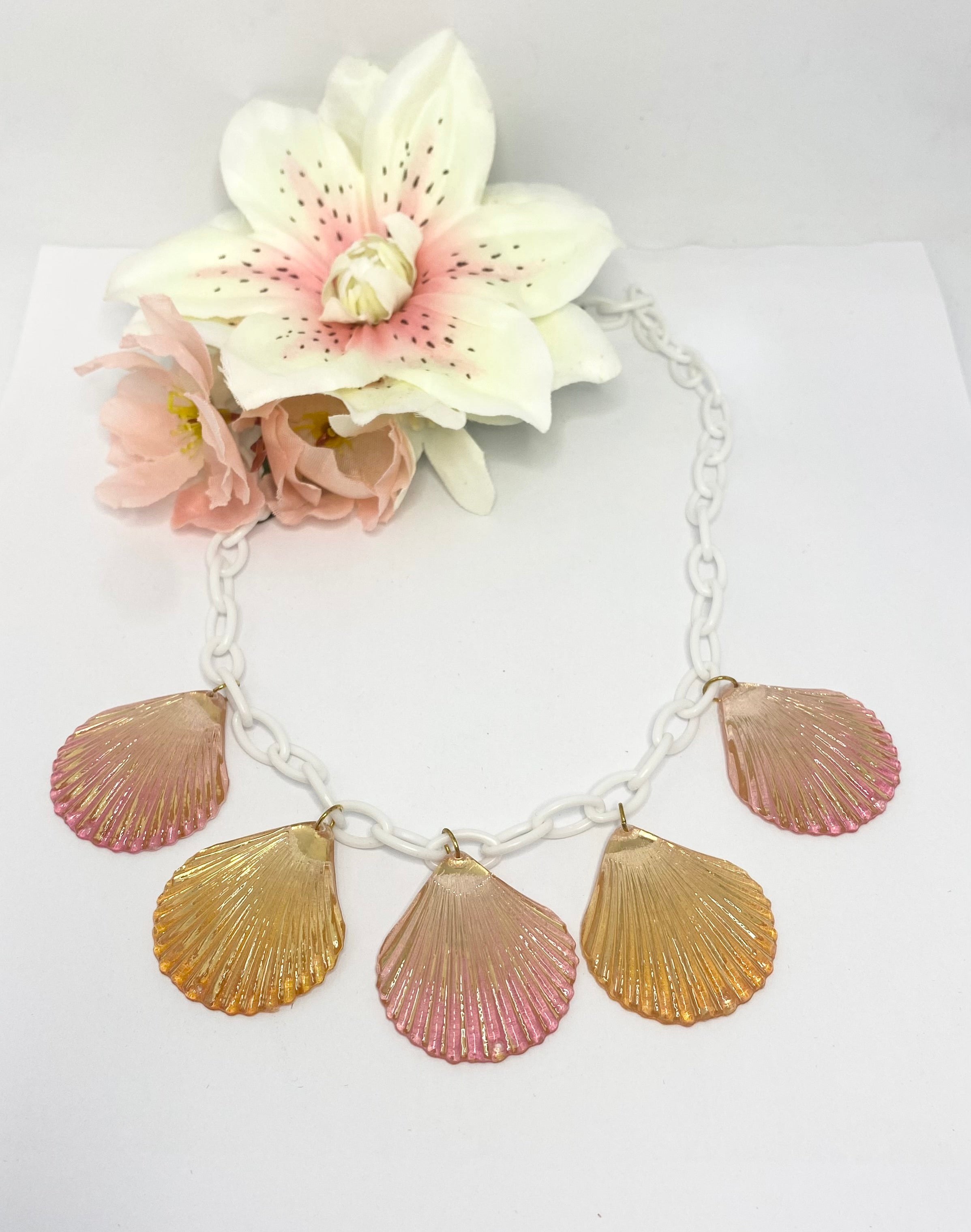 Shelly vintage style Necklace with seashell pendants and flowers on a white background