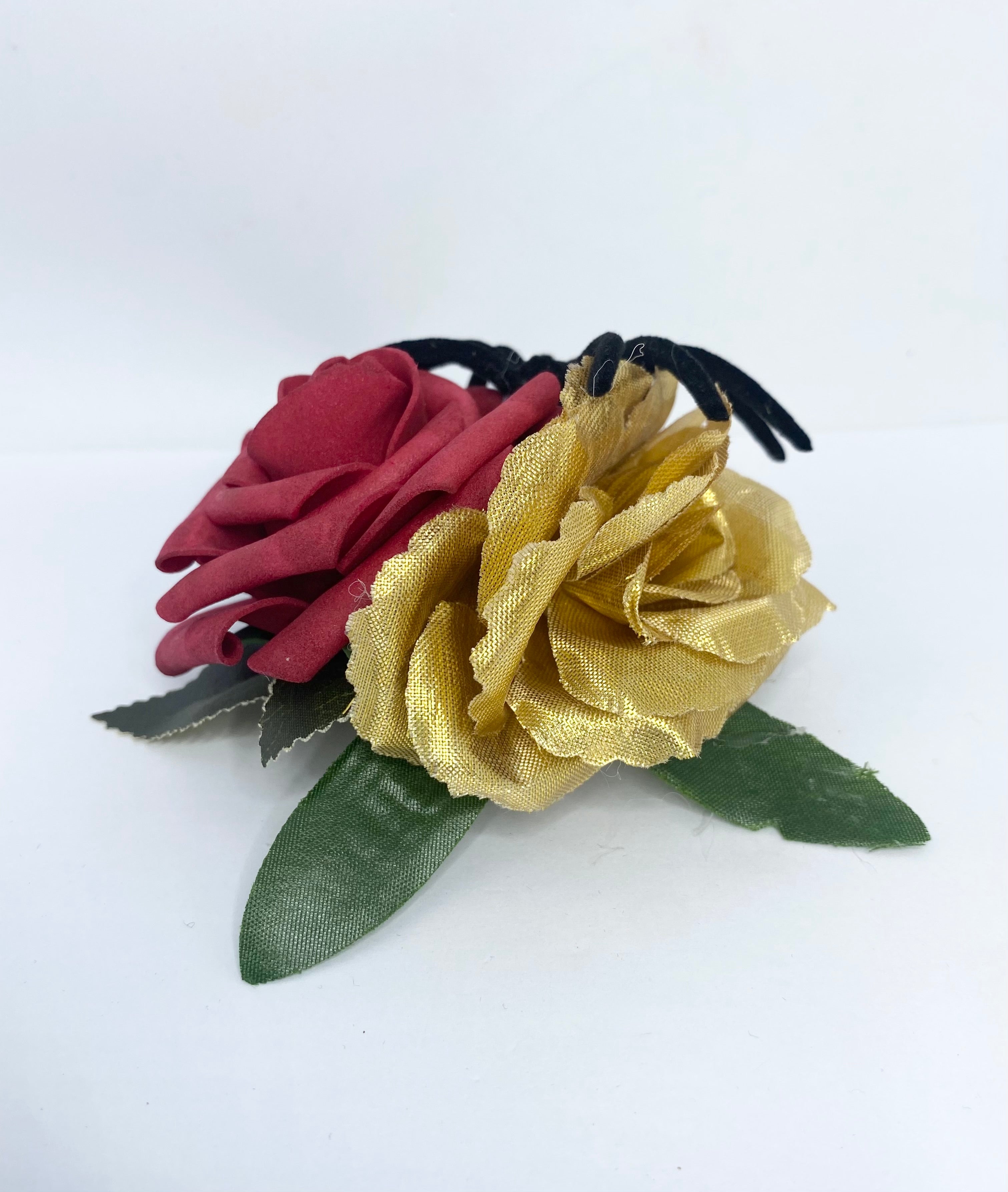 Spooky red and gold rose 1940s/1950s Halloween Hair Flower Decorative flower brooch with a red rose, gold ribbon, and black spider on a white background