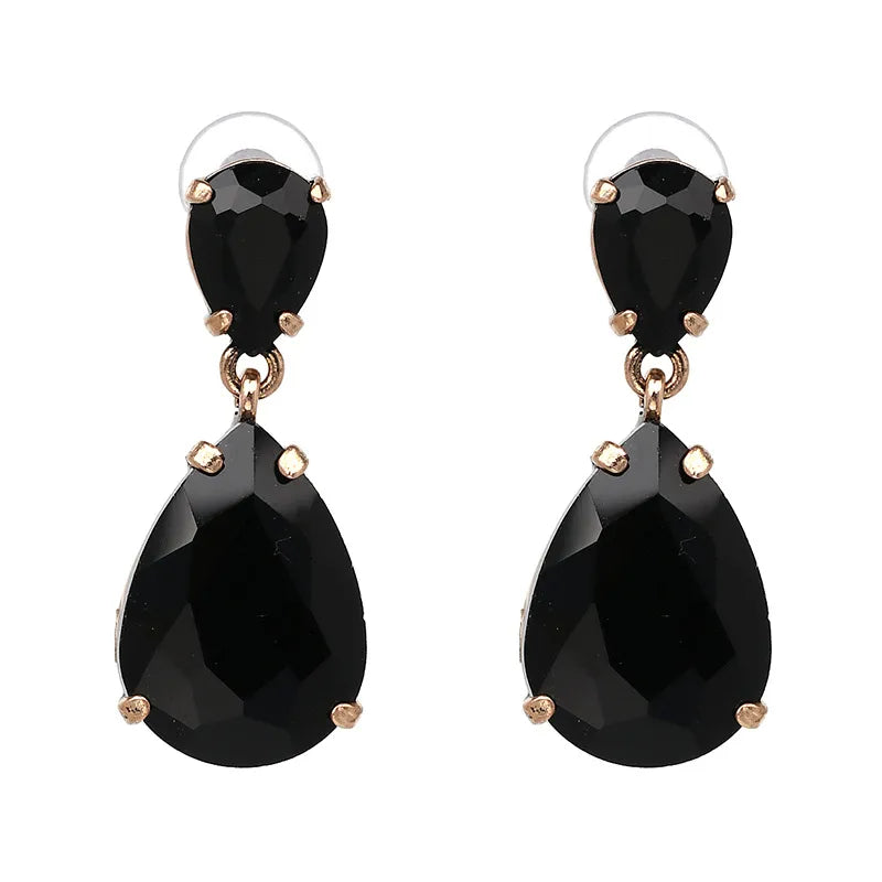 Black teardrop vintage style earrings with gold accents on a white background